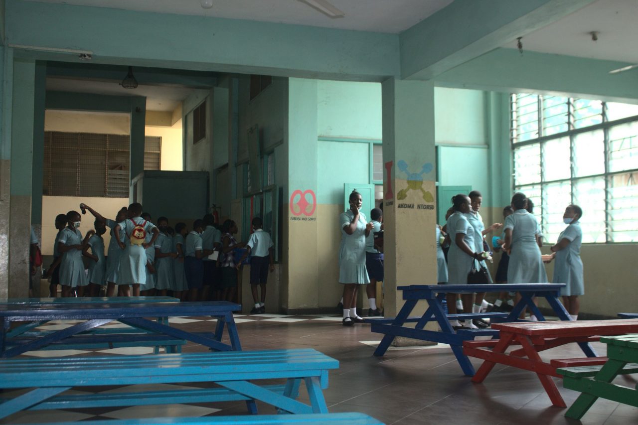 Pupils in the canteen with coloured picnic tables
