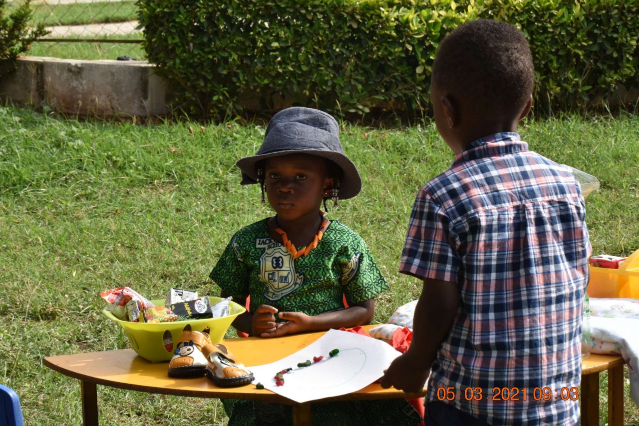 Preschool children at an outdoor activity table