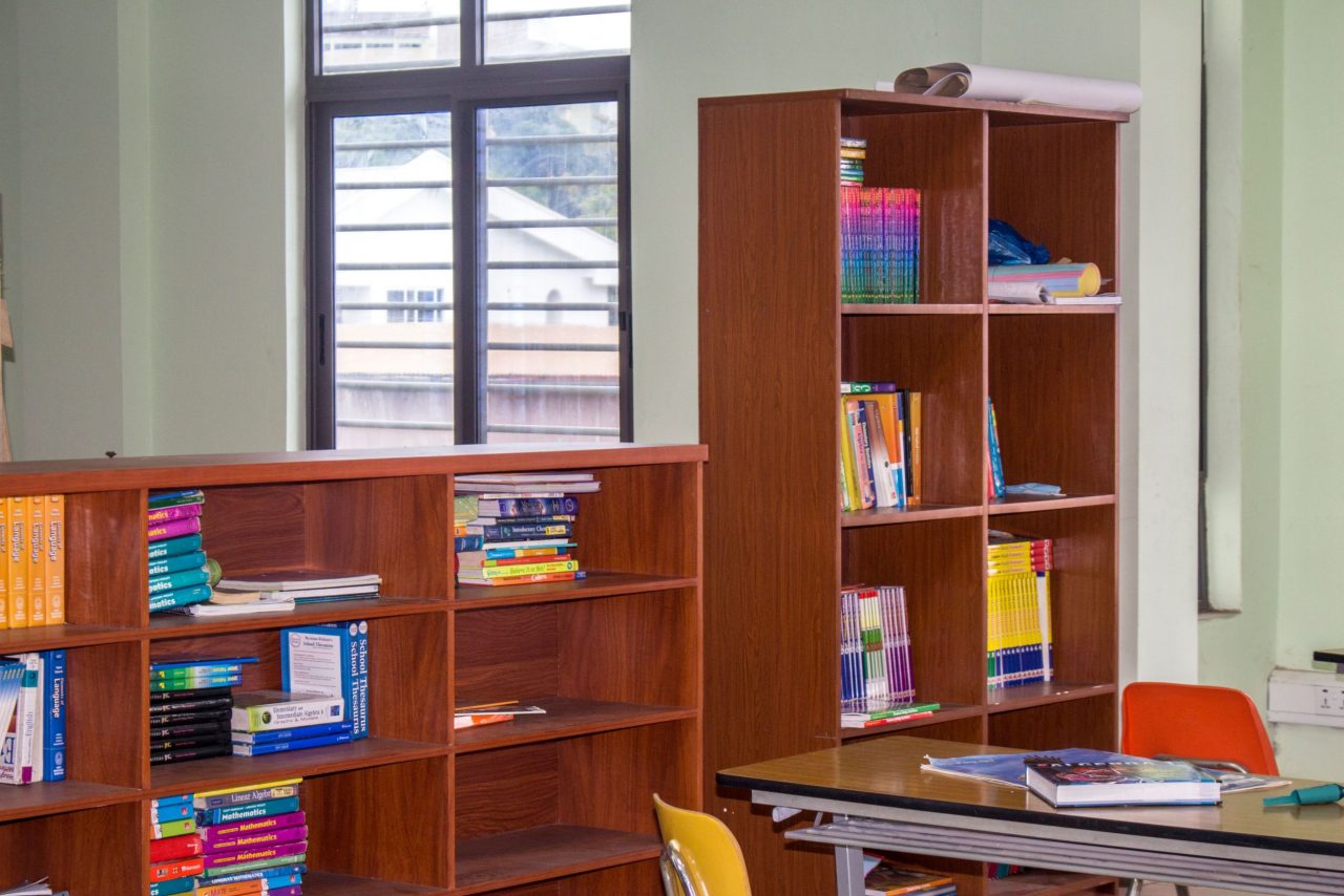 Library bookshelves packed with textbooks